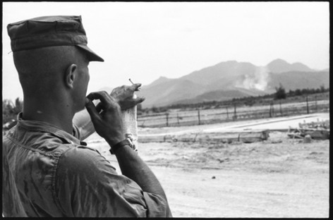 LTJG Ed Rüdiger, the detachment's OIC, points out the artillery rounds exploding on a VC location a few miles away.